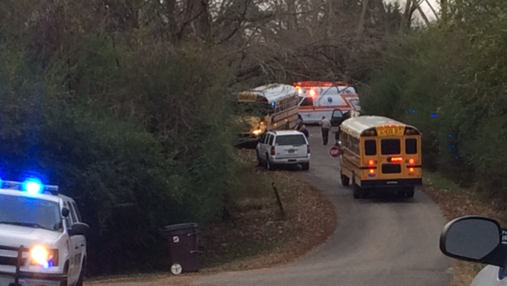 A second school bus arrives to take students home following a traffic collision on County Road 1658 in Fairivew.