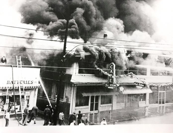 bennett.jpg In 1962, the businesses next to Bennett Auto Supply caught fire and burned down. The fire began in what was once the theater and destroyed the block, including the original All Steak Cafe. The alley, which still exists on the south side of Bennett, kept the fire from spreading. This photo shows a young Doug Bennett on the roof of the building working to prevent the fire from spreading as the fire department fought the blaze. (Bennett family)