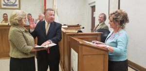 John Stam is sworn in Thursday night while wife, Deborah, holds the bible and Hanceville clerk Tania administers the oath of office