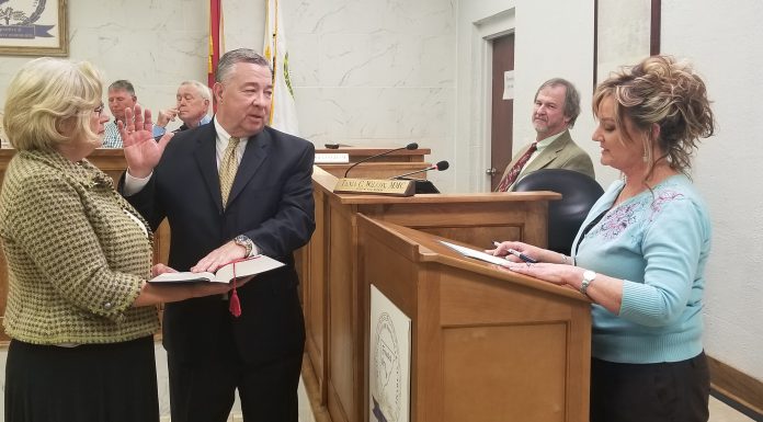 New councilmember Stam sworn at Hanceville’s council meeting John Stam is sworn in Thursday night while wife, Deborah, holds the bible and Hanceville clerk Tania administers the oath of office