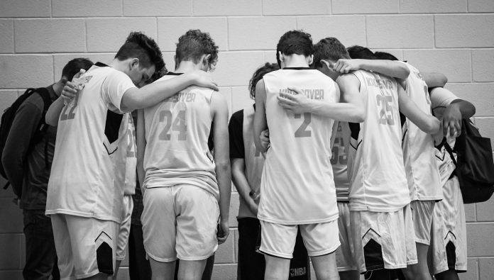  One of this year's K.B.A teams prays after a game. (Martha Needham for The Cullman Tribune) 