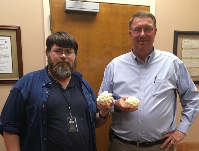 Tribune reporter W.C. Mann presenting 3D printed hailstone models to Mayor Woody Jacobs Thursday afternoon.
