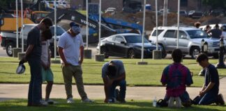 Local residents meet to pray at Depot Park after days of unrest nationwide