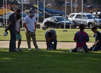 Local residents meet to pray at Depot Park after days of unrest nationwide