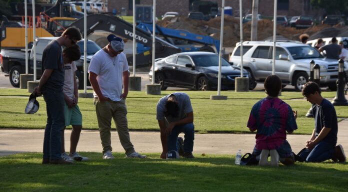 Local residents meet to pray at Depot Park after days of unrest nationwide