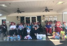 Hanceville Nursing and Rehab chapter of the Red Hat Society celebrate their completed community service project