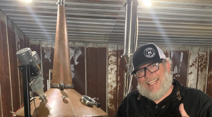 Business spotlight: Alabama Distillery Co. Patrick Watson, AKA Kat Daddy, stands in front of his beloved Shine Still, Big Lucy, at the Alabama Distillery Co. (Cheyenne Sharp)