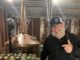Business spotlight: Alabama Distillery Co. Patrick Watson, AKA Kat Daddy, stands in front of his beloved Shine Still, Big Lucy, at the Alabama Distillery Co. (Cheyenne Sharp)