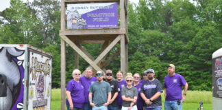 ‘He embodied service, support and love for all of our students’: Hanceville band dedicates field to Rodney Buckelew Left to right are Racheal Buckelew, Nickey Buckelew, Colton Buckelew, Karson Buckelew, Emma Buckelew, Lacie Buckelew, Veronica Wallace, Jon Sharp, Jesse James and Jeremy Buckelew with the new unveiled banner at the Rodney Buckelew practice field on Friday, May 16, 2025. (Nick Griffin)