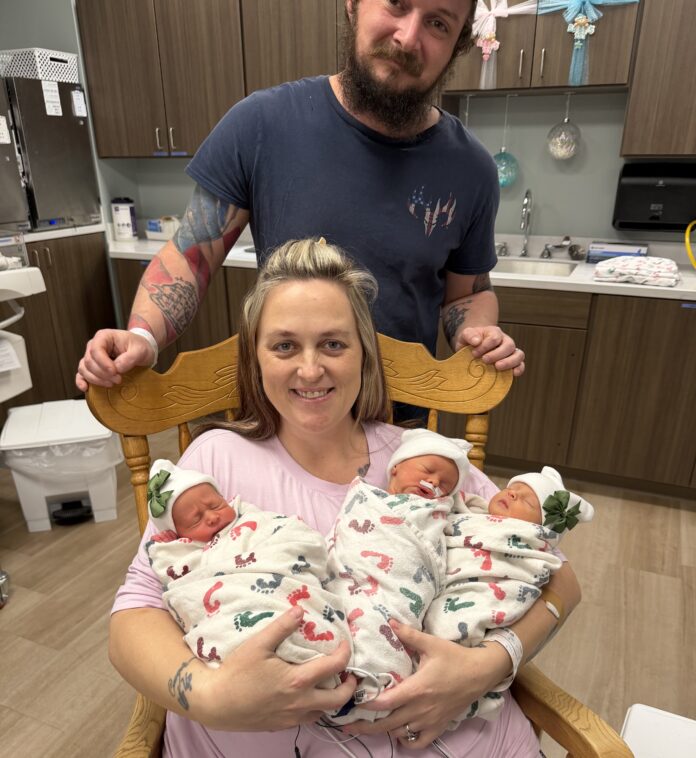 Photo 1 Dalton and Jessica Shoemake pose with their newborn triplets. (Cullman Regional)