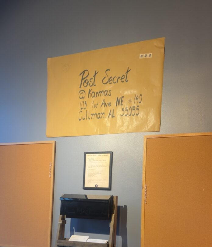 Postcard creation station in Karma’s Coffee House (Anabelle Howze/The Cullman Tribune)